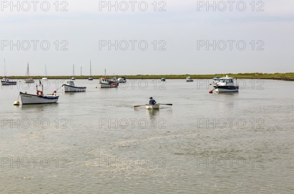 Boats at moorings on River Ore, Orford, Suffolk, England, UK