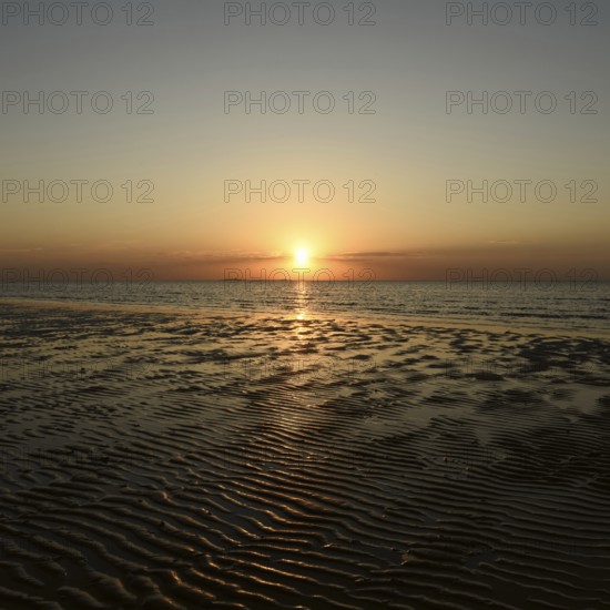 Sunset over the Wadden Sea on the German North Sea coast, low sun over Neuwerk, typical ripple