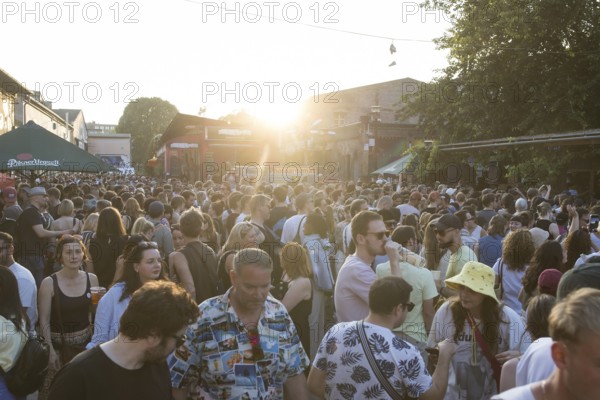 People in front of the bathhouse on the RAW grounds as part of the Fête de la Musique. The music