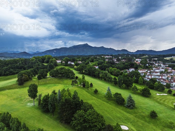 Sunset and storm clouds over Pyrenees and Saint-Jean-de-Luz from a drone, Nouvelle-Aquitaine,