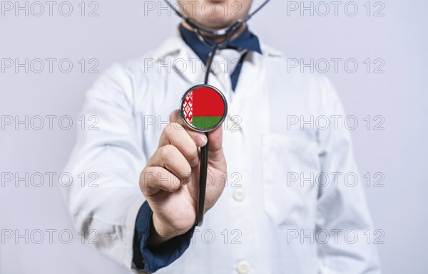 Doctor hands holding stethoscope with Belarus flag. Belarus health and care concept