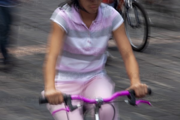 Woman riding a bicycle, Photo with motion blur, City of Quito, Pichincha province, Ecuador, South