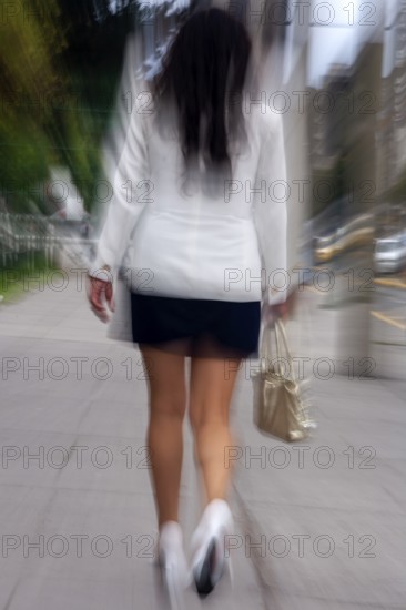 Woman walking in street, Photo with motion blur, City of Quito, Pichincha province, Ecuador, South