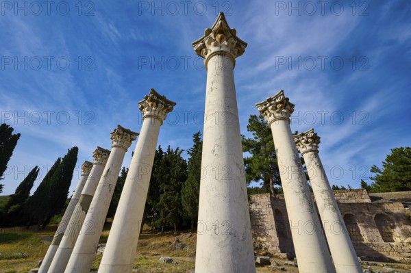Ancient columns stretch under a clear blue sky, Temple of Apollo, Corinthian Columns, Asklipion,
