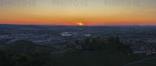 Panoramic view of a city at sunset with vineyards in the foreground and orange sky, Grabkapelle,