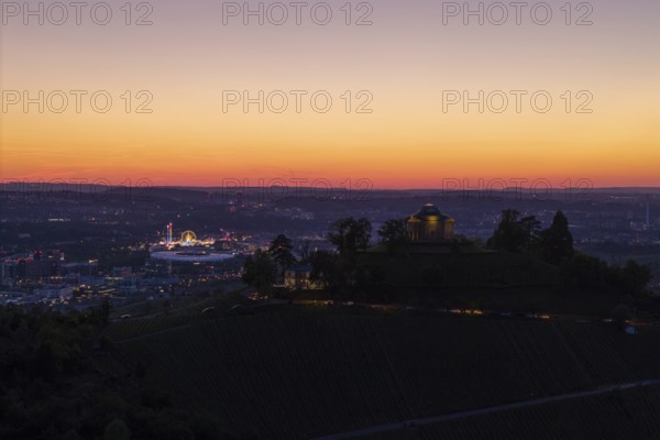 Evening atmosphere with chapel and city lights, silhouette of the vineyards at sunset, grave