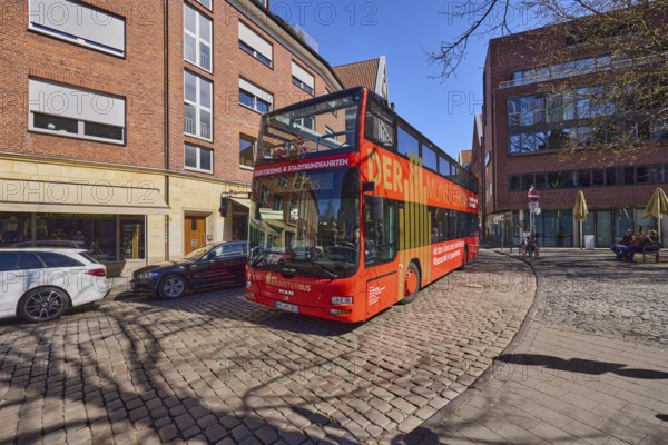 The Münsterbus, bus for city tours, tourism, general architecture, cobblestone street, blue
