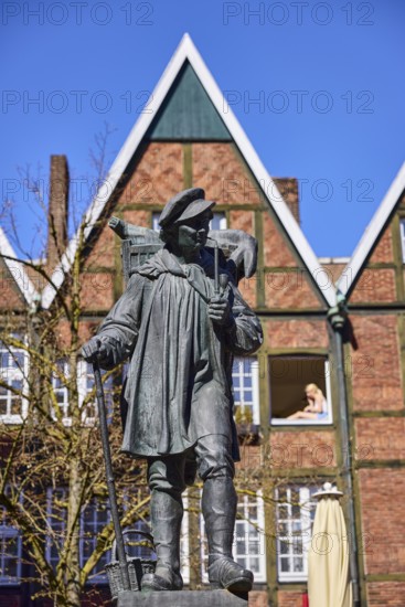 Kiepenkerl monument, bronze sculpture, brick architecture, depth of field, blue cloudless sky,