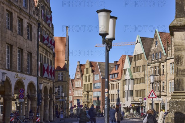 Old town, historical buildings, lantern, pedestrians as secondary motif, blue cloudless sky,