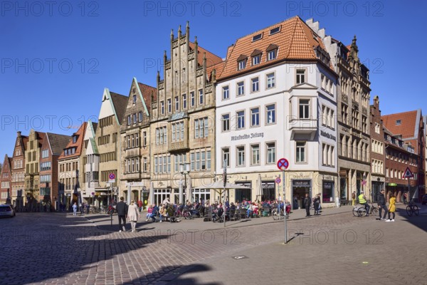Old town, historical buildings, outdoor area of a restaurant, pedestrians as secondary motif, blue