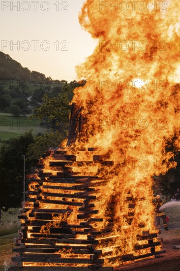 Sunset at a midsummer fire in Germany, Swabian Alb, Lenninger Tal, June 2025, firefighter in the