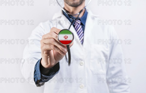Iran healthcare system, doctor holding stethoscope. Iran health and medical insurance concept