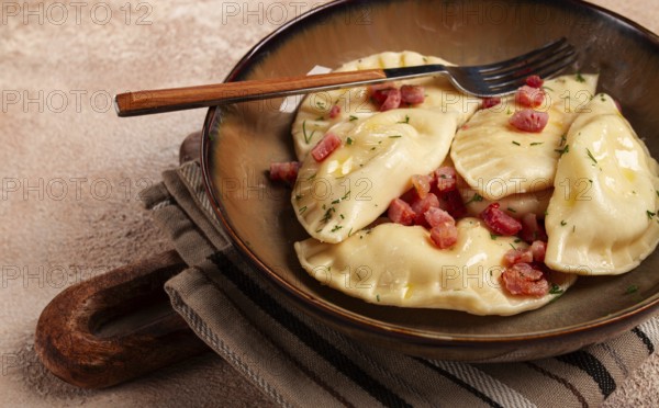 Dumplings, with fried prosciutto, a traditional dish of Polish cuisine, dumplings, top view,