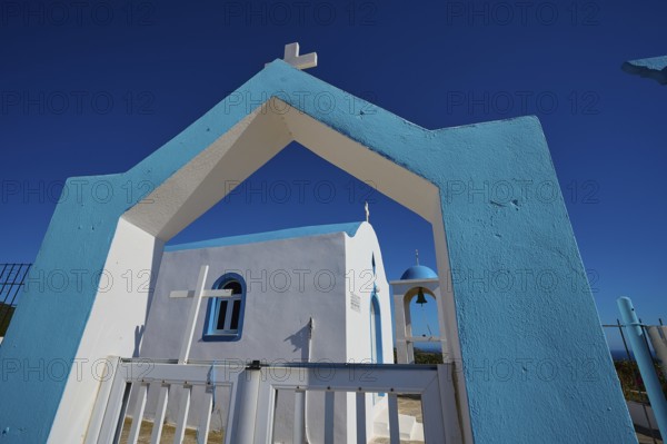 Chapel of Agios Charalambos, Blue and white Mediterranean church with an inviting entrance under a