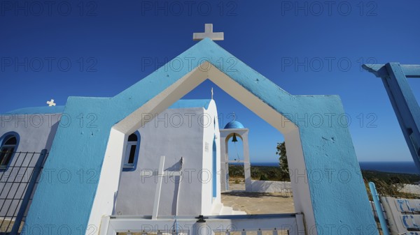 Chapel of Agios Charalambos, Blue and white Mediterranean church with clear sky and sea view,