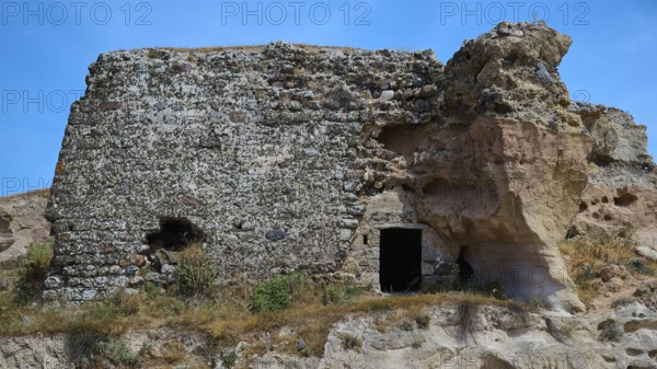 Ruins of a castle, Dilapidated stone ruins with exposed walls, surrounded by natural landscape