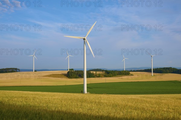 Wind turbines in a wide, green landscape under a clear sky, summer, Höhefeld, Wertheim,