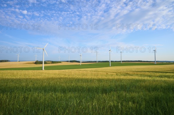 Wind turbines in a wide, green landscape with blue sky, summer, Höhefeld, Wertheim,