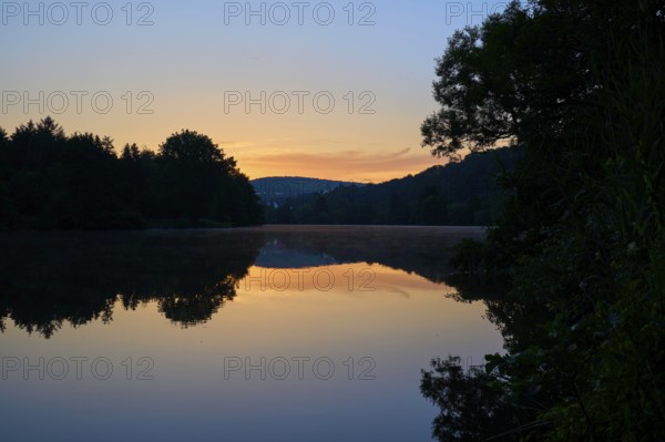 Twilight steals over a quiet river Main, whose water reflects the soft colours of the sky, summer,