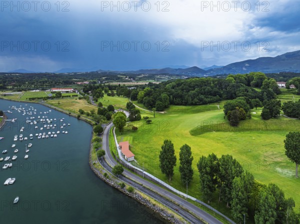 Sunset and storm clouds over Pyrenees and Saint-Jean-de-Luz from a drone, Nouvelle-Aquitaine,