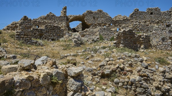 A vast field of ruins with brick arches under a bright blue sky, Abandoned Village, Lost Place,