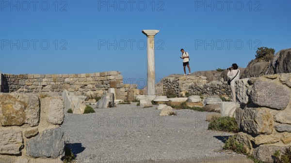Ancient ruins with a medium-sized column and blue sky in the background, Agios Stefanos Beach,