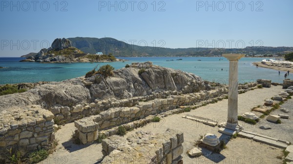 Ruins with a view of an island in the background, bright blue sea, Agios Stefanos Beach, Agios