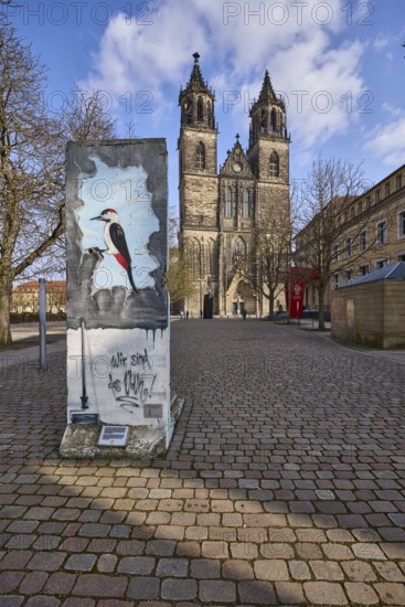 Part of the Berlin Wall, memorial to the fall of the Berlin Wall, cathedral, blue sky, cumulus