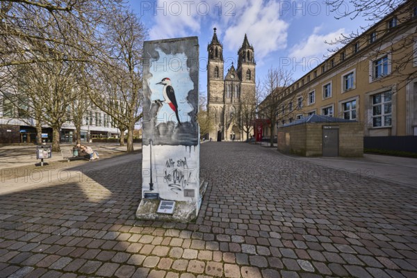 Part of the Berlin Wall, memorial to the fall of the Berlin Wall, cathedral, bare wintry trees,