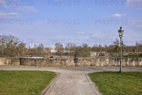 Park, lantern, city fortification, city wall, bare wintry trees, blue sky, cumulus clouds,