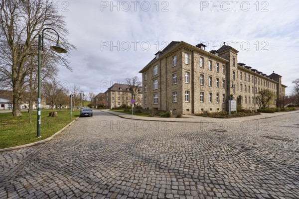 Tax office, sandstone building, bare wintry trees, lantern, diffuse light, slightly sunny, milky
