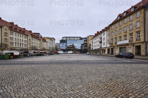 Old town, sandstone building, modern architecture, glass facade, cobblestone square, weekly market