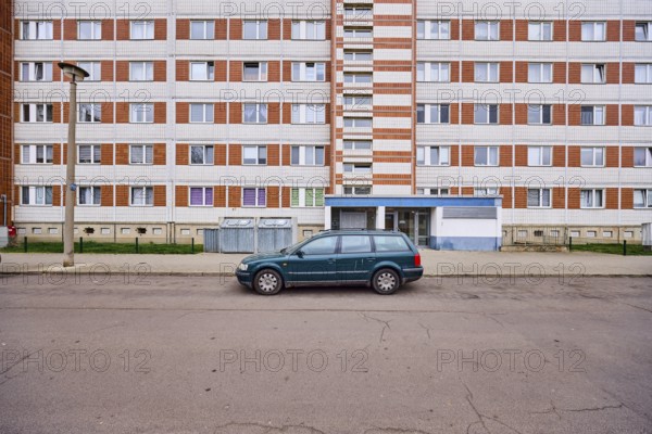 High-rise building, residential building, facade, window, door, parking lane, vehicle, lantern,