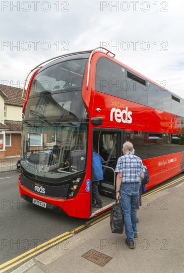 Passengers boarding Salisbury Reds double decker bus service X5 at Pewsey, Wiltshire, England, UK