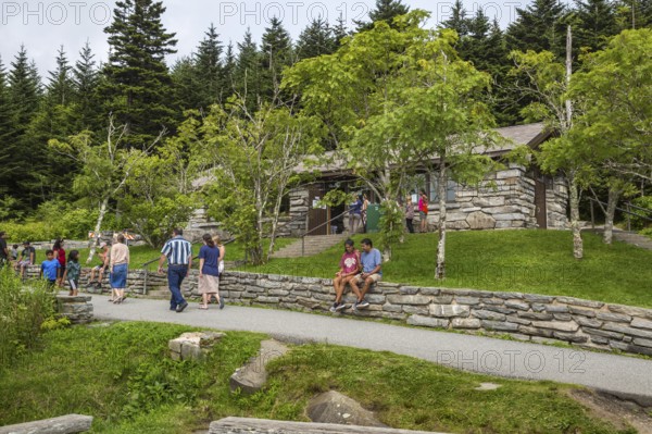 Park guests resting on stone wall outside the store at Clingman's Dome in the Great Smoky Mountains