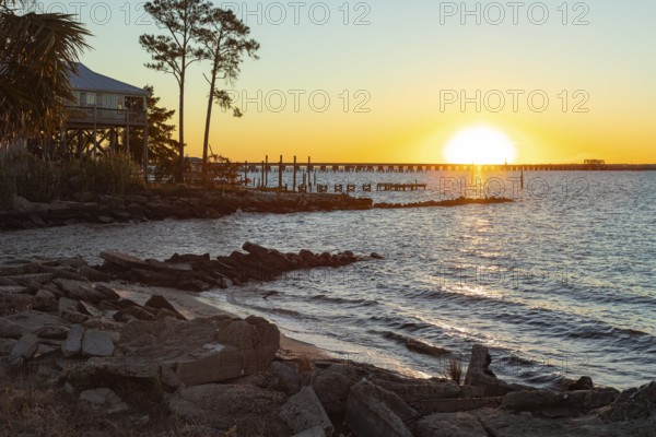 Sunset over the railroad bridge across Bay of Saint Louis from Henderson Point in Pass Christian,