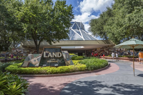 Family and senior couple entering The Land attraction in Epcot at Walt Disney World in Orlando,