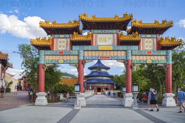 Masked park guests near the entrance to the China area of Epcot at Walt Disney World in Orlando,