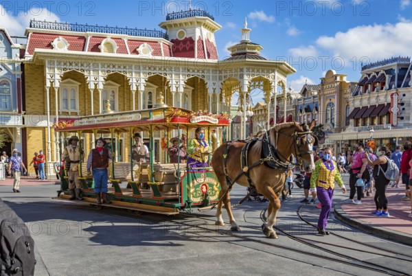 Horse pulling trolley car with Disney characters down Main Street in the Magic Kingdom at Walt