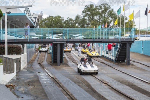Black man and son riding a car in the Tomorrowland Speedway at the Tomorrow land area of the Magic