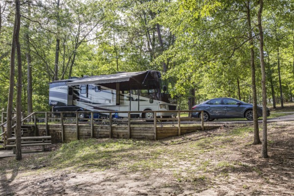 Motorhome parked in a campsite on the bank of the lake at Little Black Creek campground near