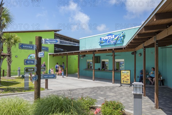 Sign outside the Turtle Cafe directs guests to different attractions at Ocean Adventures Marine
