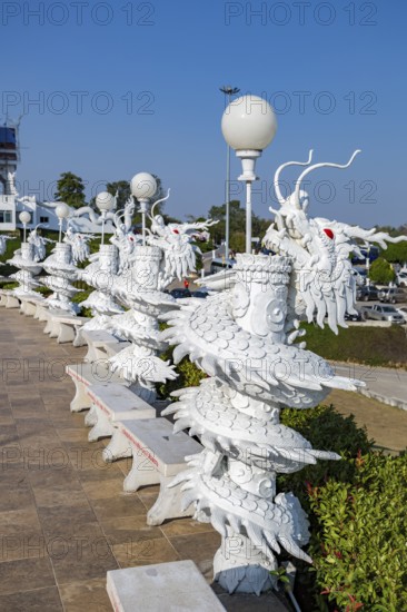 Ornate dragon sculptures around the perimeter of the Guan Yin (Goddess of Mercy) statue at Wat Huay