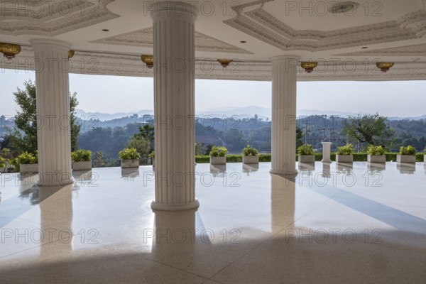 Hills beyond the supporting columns under the Guan Yin (Goddess of Mercy) statue at Wat Huay Pla