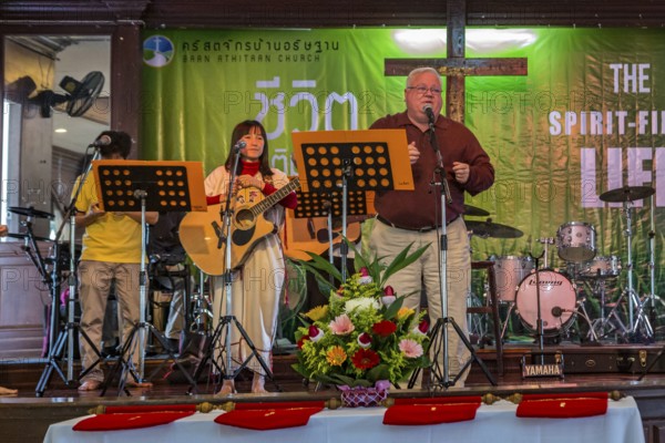 Pastor Michael Johnson speaking at the Baan Athitaan Church and Grace Language School in Chiang