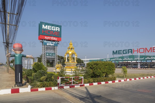 Buddahist shrine outside of the Mega Home building materials warehouse store in Chiang Rai province