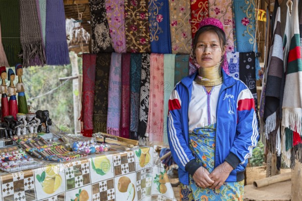 Tribal woman selling woven scarves and other crafts in the Long Neck Karen tribe (more properly