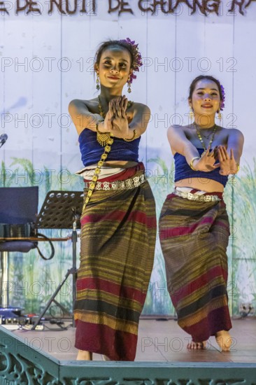 Traditional Thai dancers perform on a lighted stage at the night market in downtown Chiang Rai,