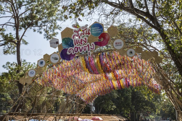 Sign above the colorful arched entrance to the Doi Tung tourist attraction in Chiang Rai, Thailand