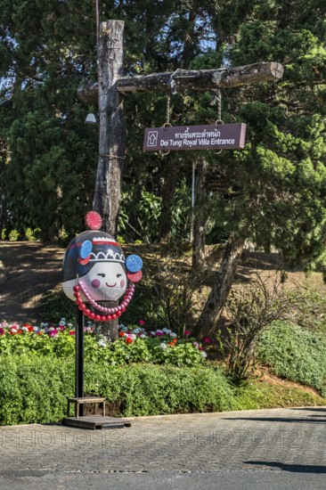 Sign points to the entrance tot he Doi Tung Royal Villa inside the Doi Tung tourist attraction in